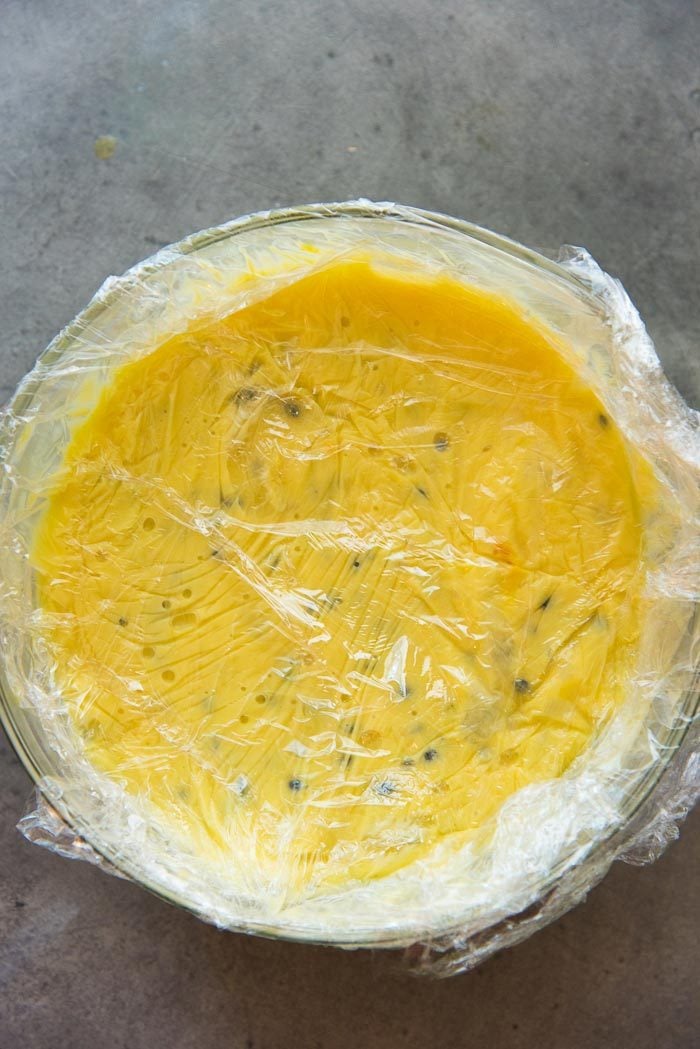 Once the passion fruit curd is thickened, a plastic wrap is placed on the surface of the curd until the passion fruit cools down (if you're using it within a few days). 