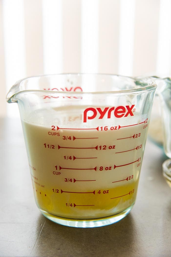 Milk and Eggs placed in a jug, measuring 2 cups, or 16 fl oz. This will be mixed with the flour to make perfect crepes.