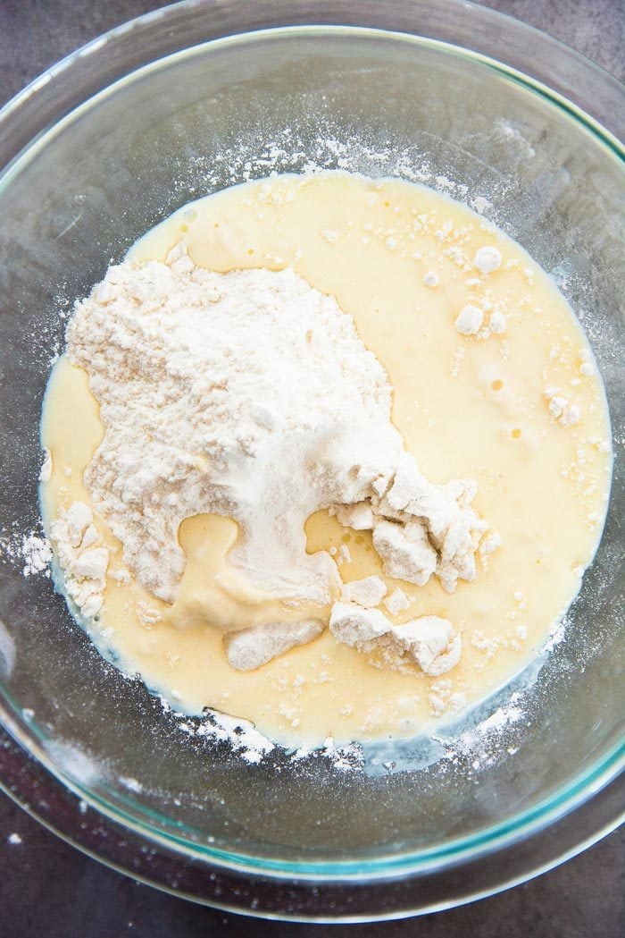 Half of the liquid has been added to the flour. By mixing this, it will create a lump free batter. 