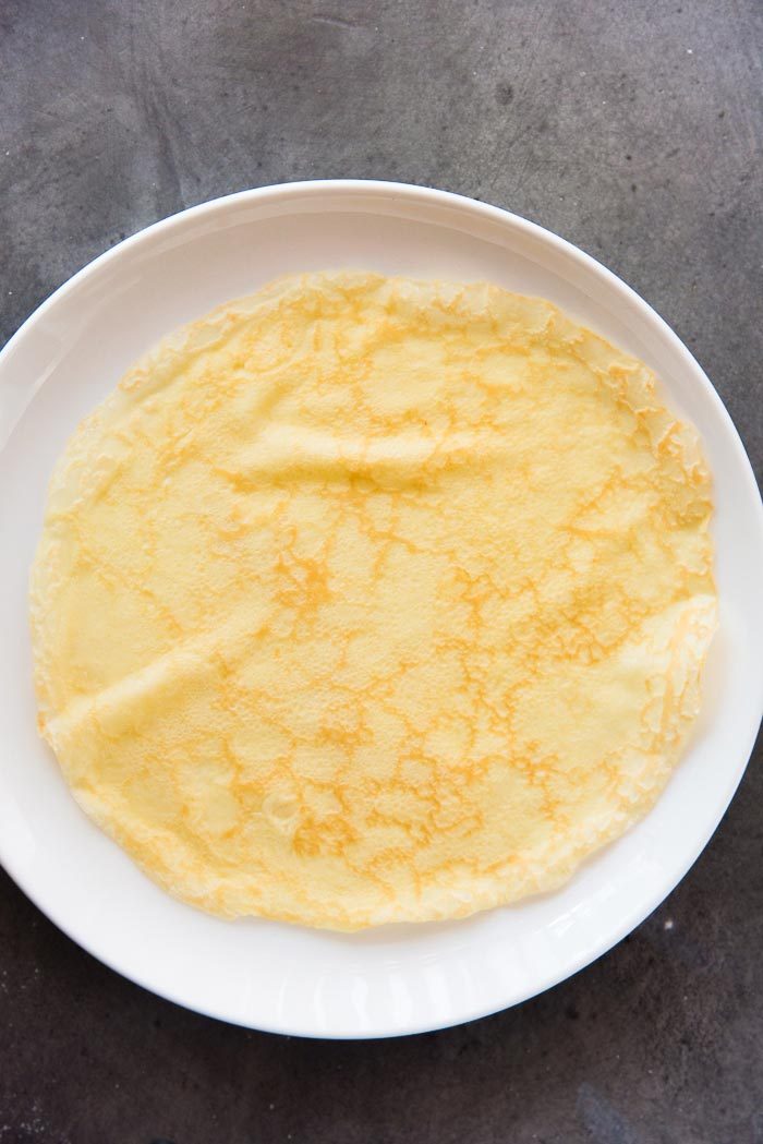 A crepe that has not been cooked on both sides. Very light caramelization, and the crepes are soft. This is one way to cook crepes. 