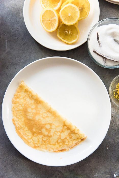 Step 3 of making lemon and sugar crepes - Fold over the crepe in half.
