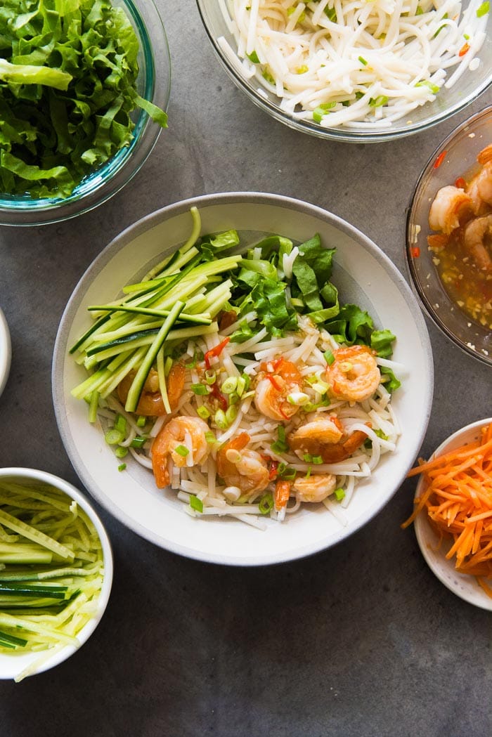 Assembling Garlic Lime Shrimp Rice noodle salad. Add the julienne cucumbers