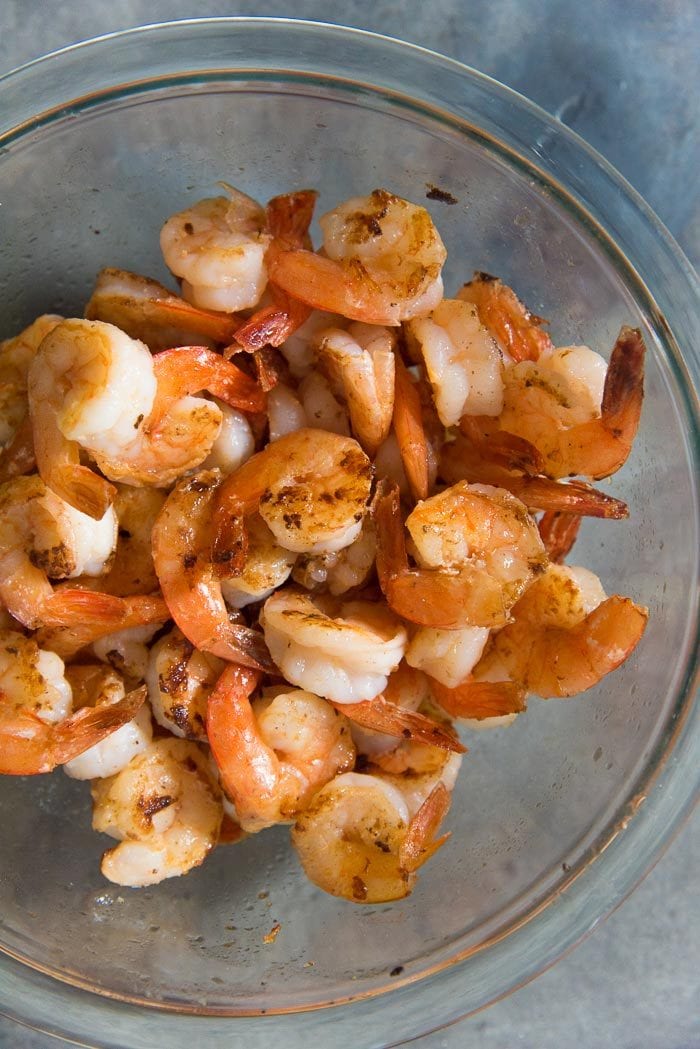 Pan frying shrimp with minimal seasoning in a bowl. These shrimps are a perfect canvas for any flavor and can be tossed in any kind of sauce. 