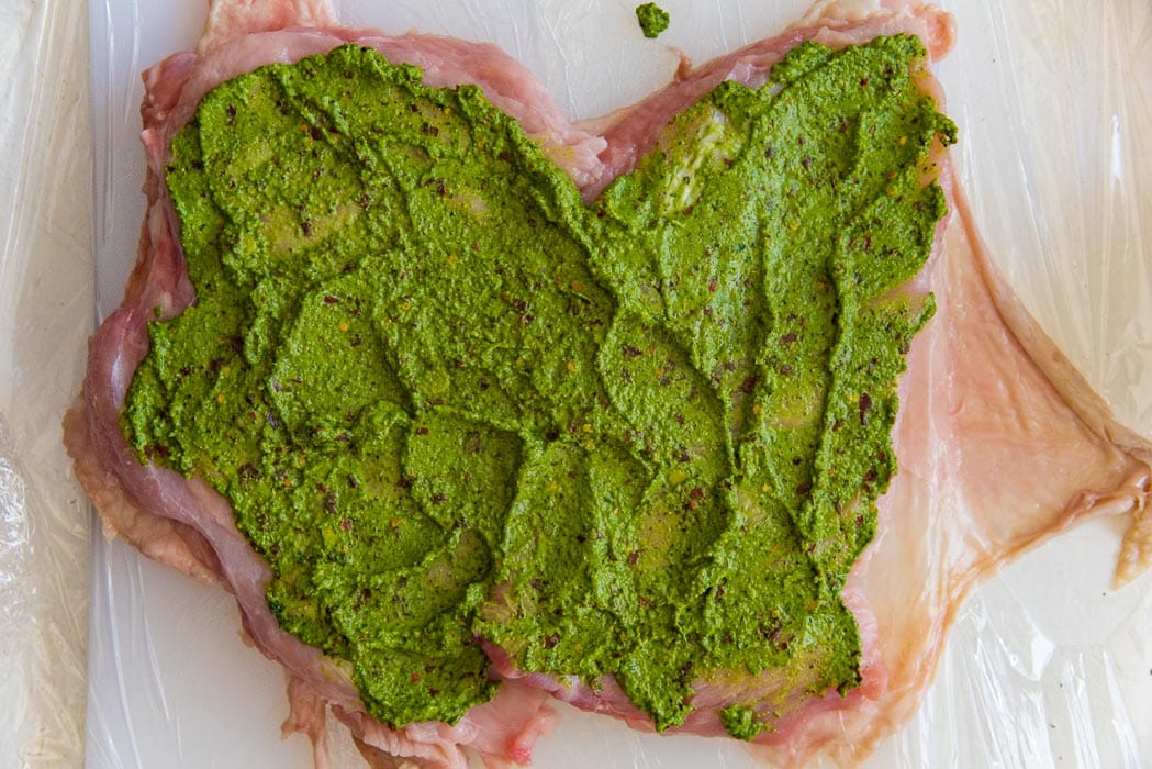 Spread out the herb mix on the butterflied turkey breast meat.