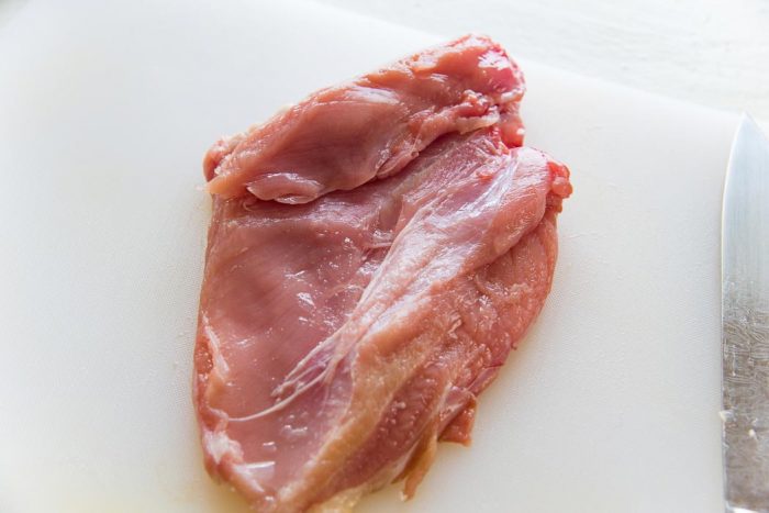 Make a shallow cut on the turkey breast, where it is thicker than the rest of the piece. Make shallow cuts to "butterfly" the turkey breast to make it an even thickness.