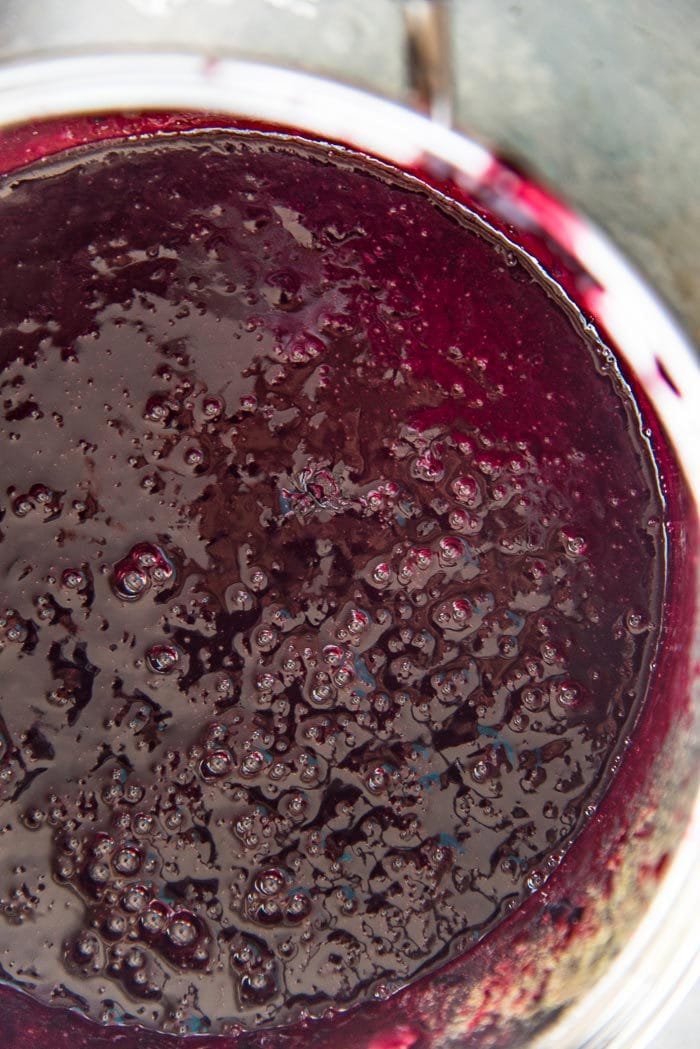 The concord grape skin blended and added back to the grape juice in the saucepan, ready to be cooked into jam.