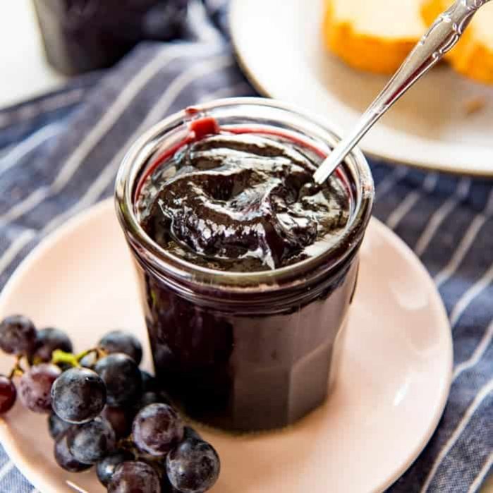 This Homemade Concord Grape Jelly recipe (Concord Grape Jam) is so easy, and so delicious! Perfectly tart and sweet and perfect on everything!