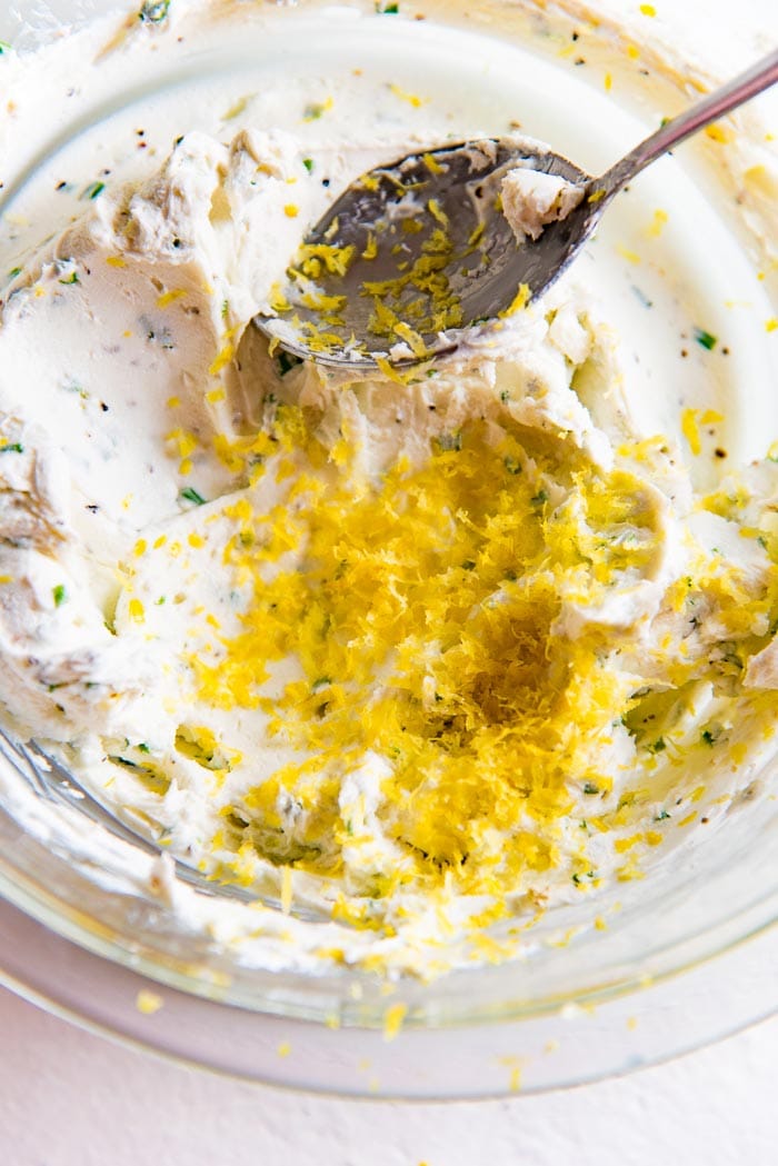 The goat cheese filling mixed in a bowl, with lemon zest added to it.
