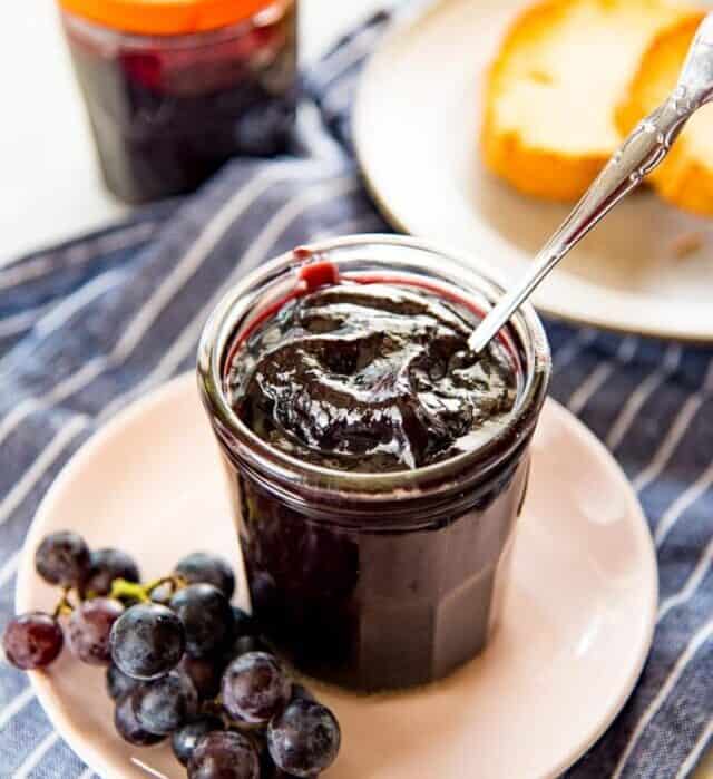 This Homemade Concord Grape Jelly recipe (Concord Grape Jam) is so easy, and so delicious! Perfectly tart and sweet and perfect on everything!