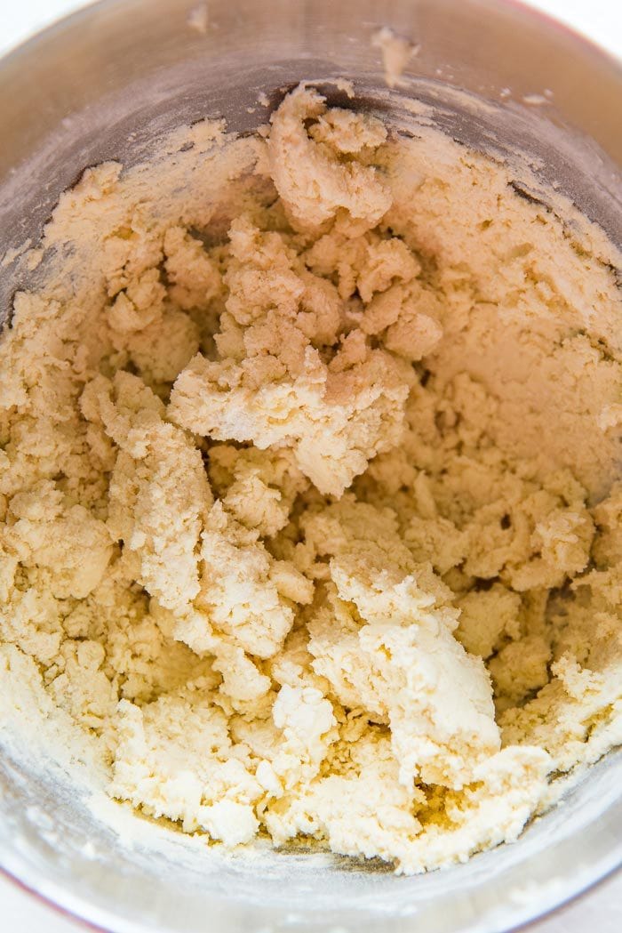 The flour incorporated into the butter mixture, forming wet clumps. Do not mix more than this to avoid tough cookies.