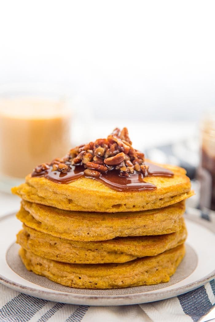 Easy Pumpkin Pancakes - Deliciously fragrant, light and fluffy pumpkin pancakes, spiced with pumpkin spice and pumpkin puree and topped with a maple pecan topping! It's even easier to make with the pancake waffle mix! 