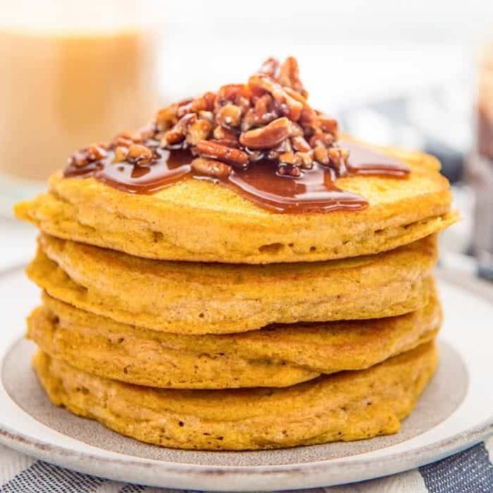 Easy Pumpkin Pancakes - Deliciously fragrant, light and fluffy pumpkin pancakes, spiced with pumpkin spice and pumpkin puree and topped with a maple pecan topping! It's even easier to make with the pancake waffle mix! 