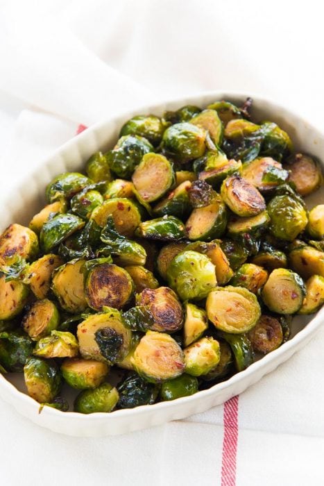Maple Roasted Brussels Sprouts - A healthy, simple side dish for Thanksgiving, Christmas or any roast dinners. Deliciously crispy and caramelized with sweet and spicy flavors. Vegan and Paleo.