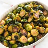 Maple Roasted Brussels Sprouts - A healthy, simple side dish for Thanksgiving, Christmas or any roast dinners. Deliciously crispy and caramelized with sweet and spicy flavors. Vegan and Paleo.