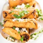Mini Chicken Taquitos - Crispy mini taquitos filled with a creamy, tangy chicken and cheese filling, perfect as appetizers for any party. Make these as a snack, appetizer or even as a meal. 