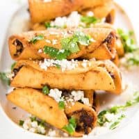 Mini Chicken Taquitos - Crispy mini taquitos filled with a creamy, tangy chicken and cheese filling, perfect as appetizers for any party. Make these as a snack, appetizer or even as a meal. 