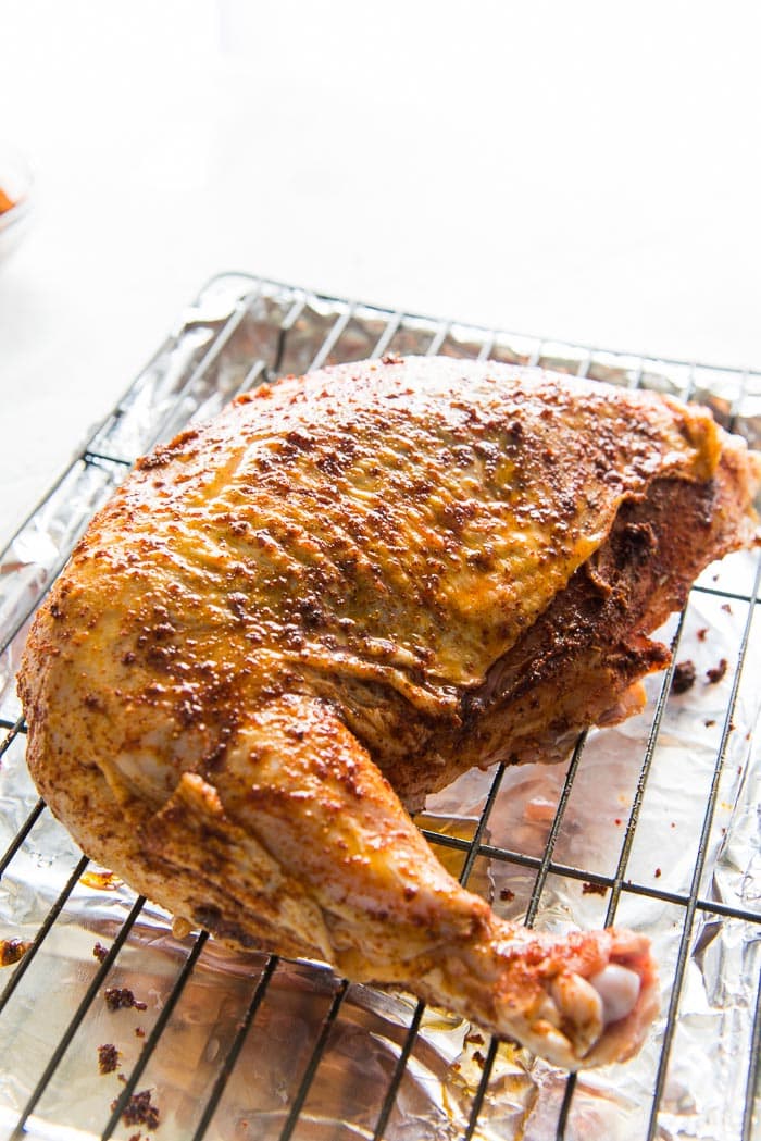 A Cajun spice rubbed Frenched Turkey breast cut on a roasting rack.