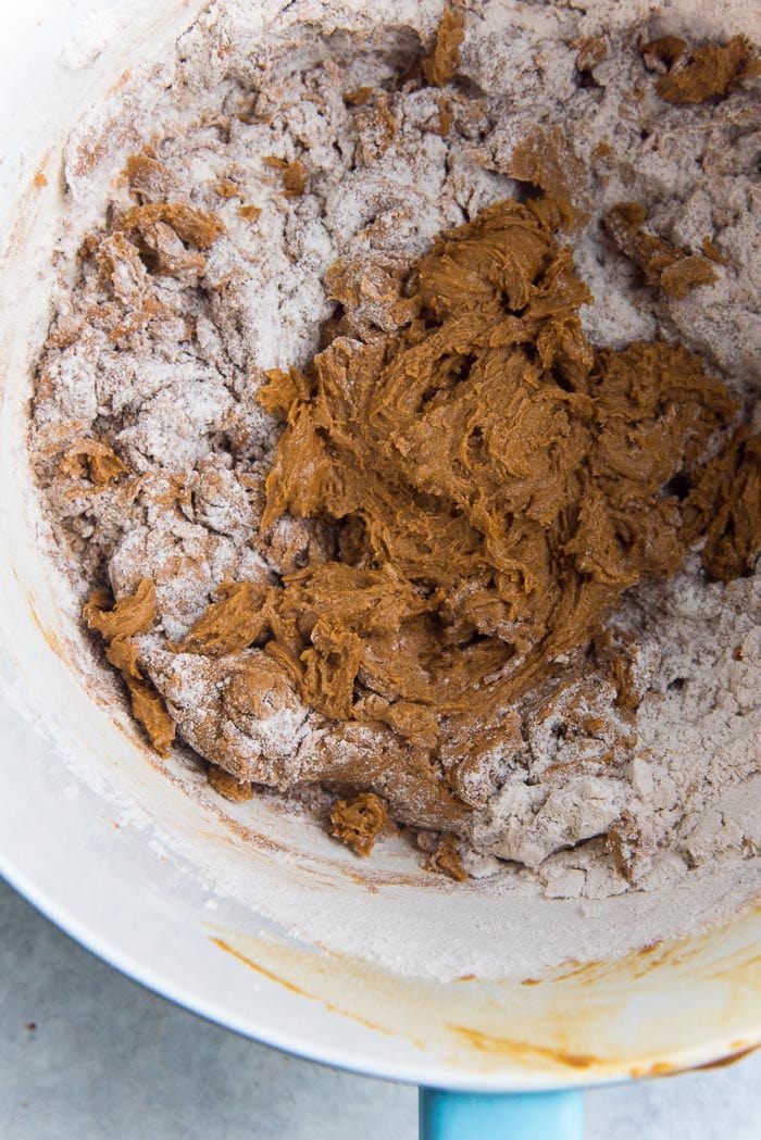 Cheesecake stuffed gingerbread cake recipe process - Dry ingredients being added to the gingerbread cake batter