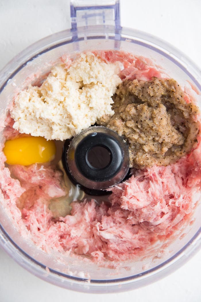 Pork mince in a food processor bowl with the spice mix, milk soaked panko crumbs and an egg.