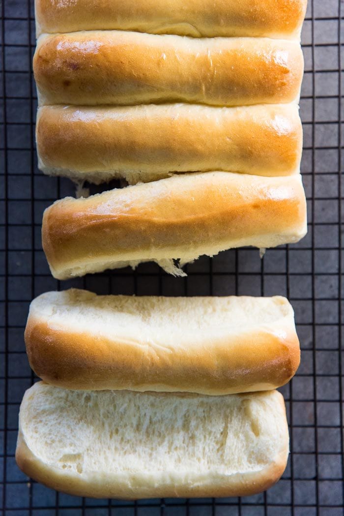 New England Hot Dog Buns on a wire rack, with the buns separated from each other to show the soft sides.