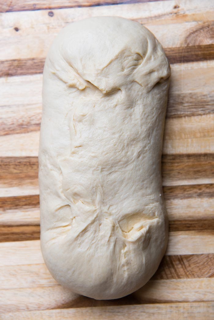 The dough has been wrapped, with the seams pinched and sealed.