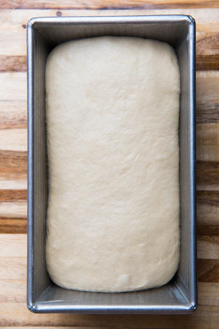 Place the dough into the loaf pan, with the smooth side facing up.