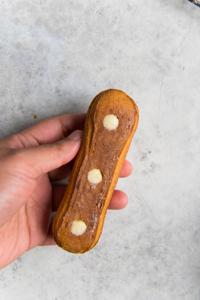 How to fill a classic eclair - once it's been filled remove the excess pastry cream from the holes.