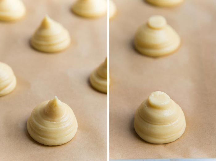 How to make perfect choux pastry - Piping profiteroles. First photo showing piped choux pastry with minimum ripples, and the pastry forms a point on top. The second image has the choux pastry tips flattened with a wet finger tip