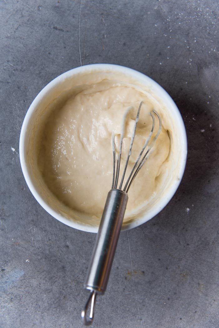 The flour paste for hot cross buns crosses, in a bowl with a small whisk.