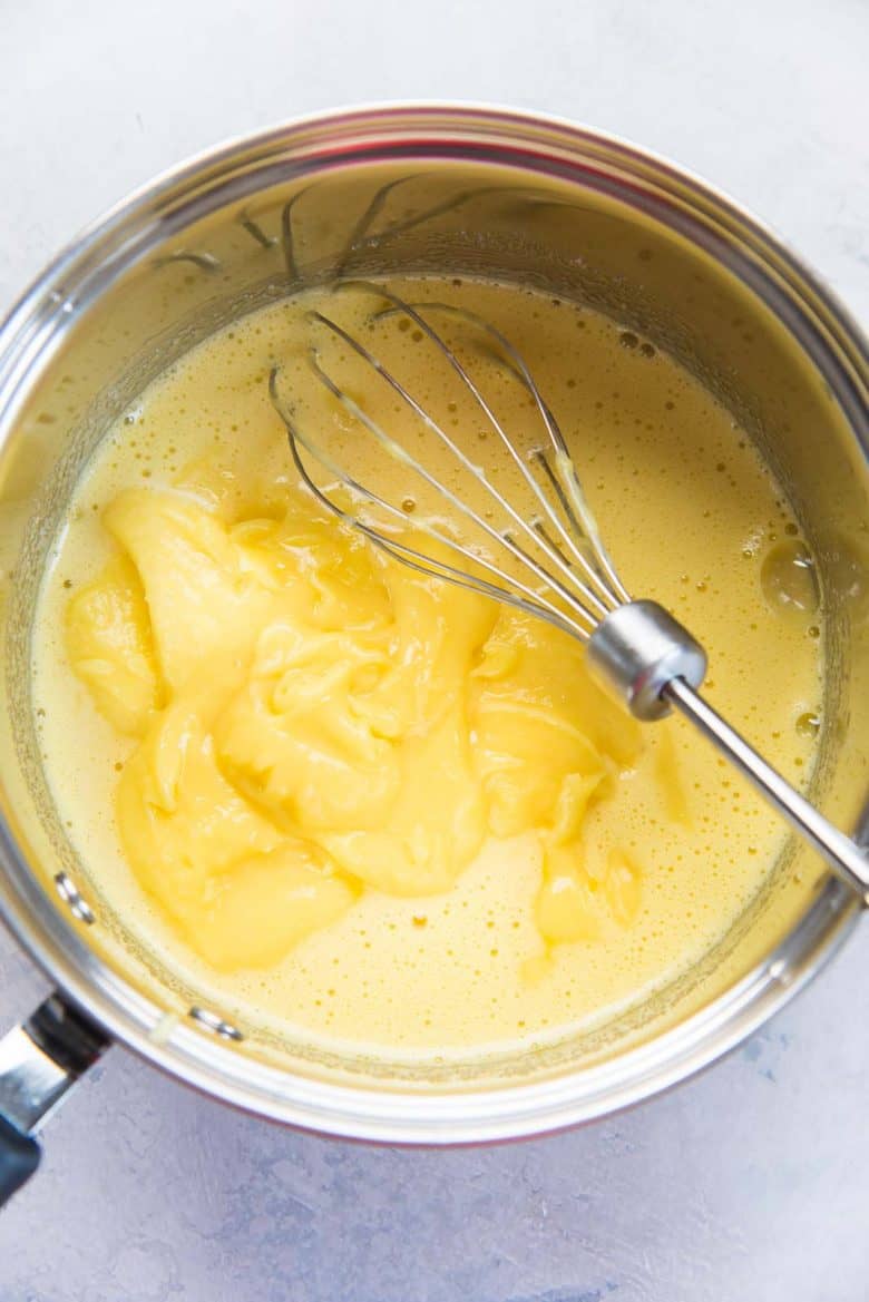 Lemon curd with the egg yolks in a saucepan to make lemon ice cream
