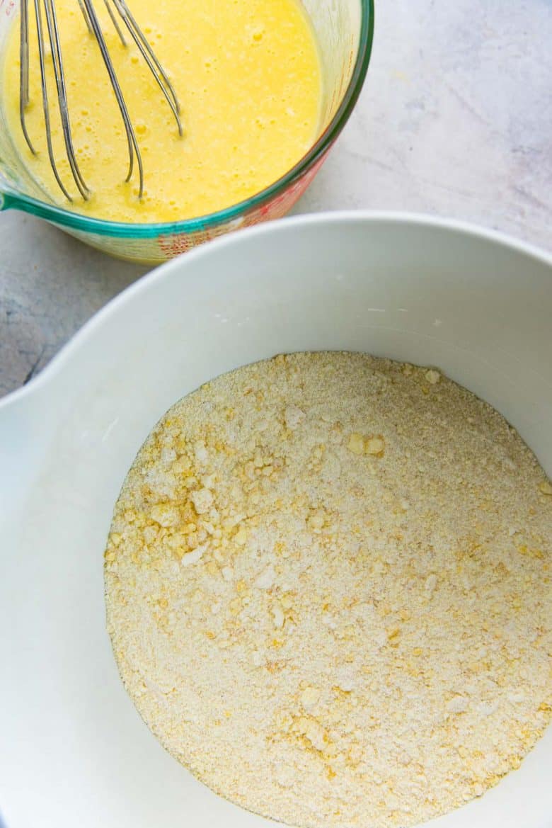 Dry ingredients and wet ingredients to make lemon cake in separate bowls