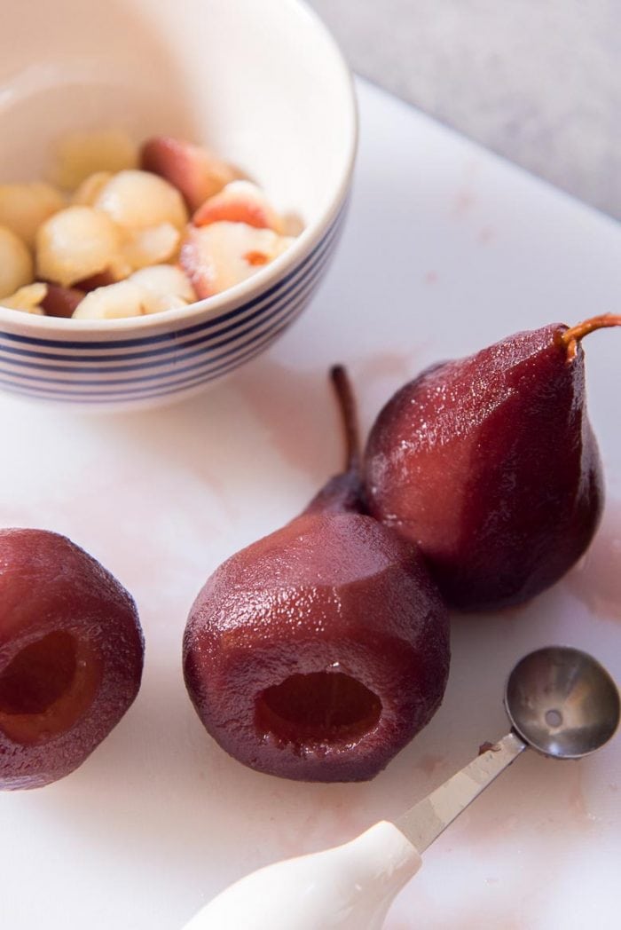Poached pears being hollowed out for the stuffing