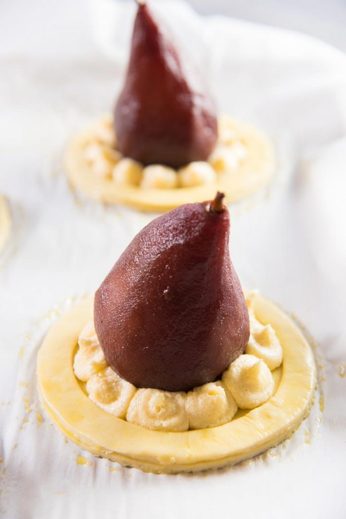 Frangipane filling piped into the tart around the poached pear.