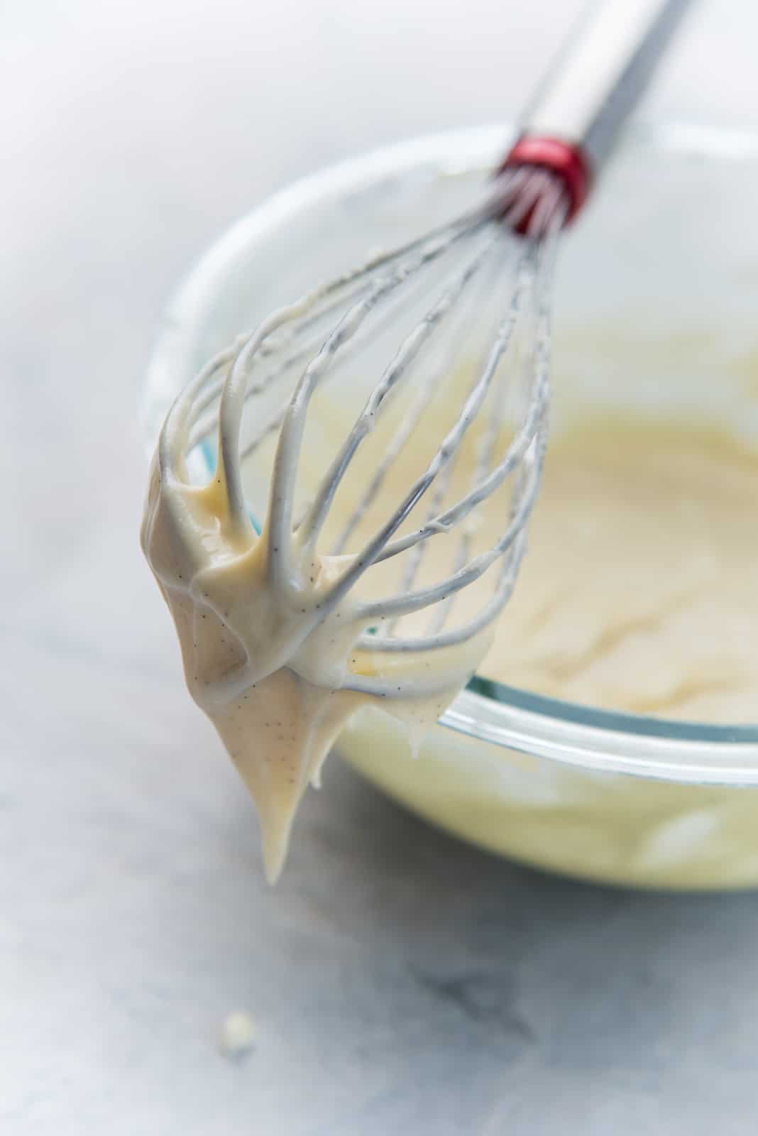 A close up of the cream cheese frosting for the cinnamon buns