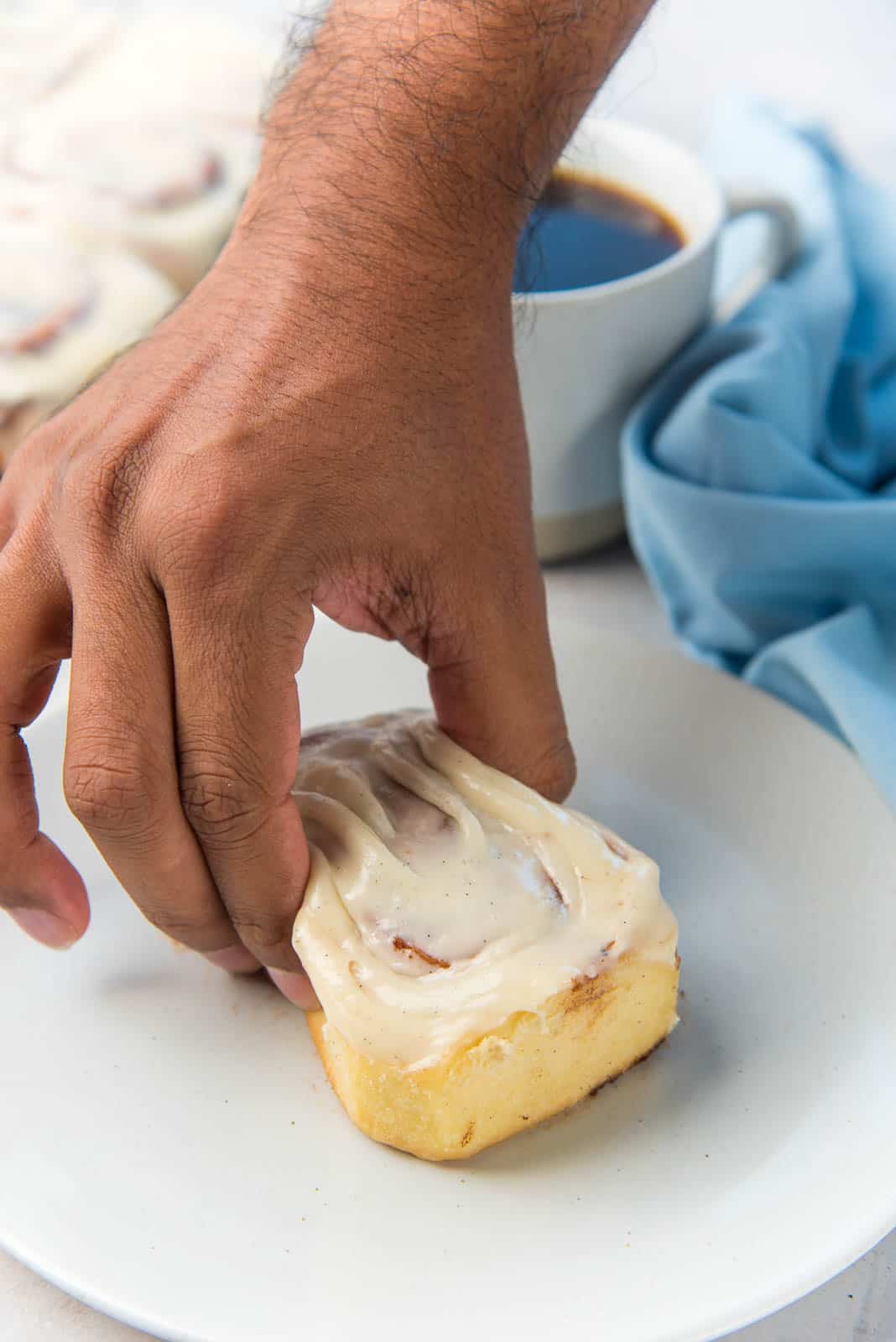 Squeezed cinnamon bun, to show how soft the brioche bun base is