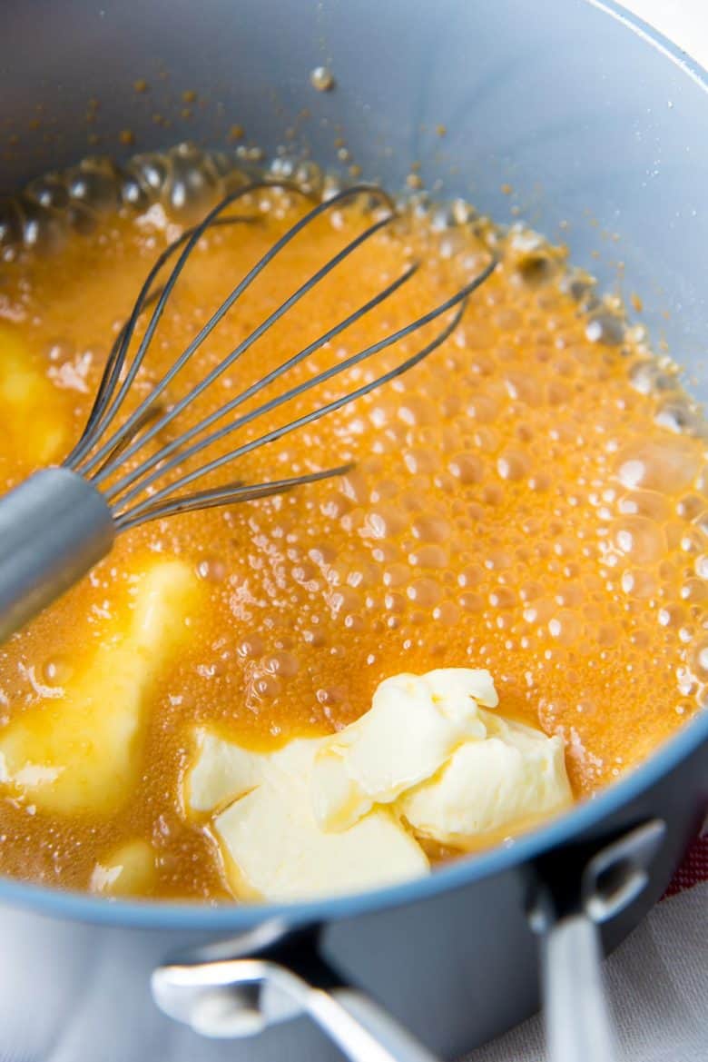 Adding butter to the caramel sauce