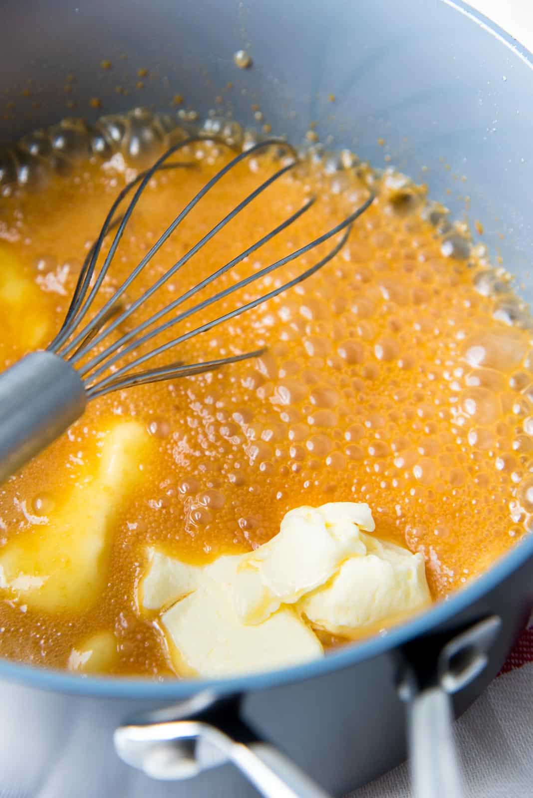 Adding butter to the caramel sauce