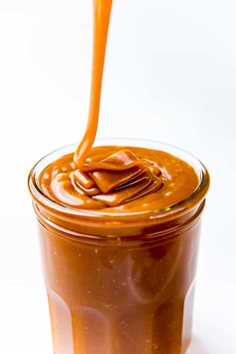 Pouring caramel sauce in glass jars