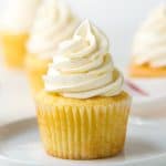 A vanilla cupcake with a big swirl of classic Swiss meringue buttercream on top.