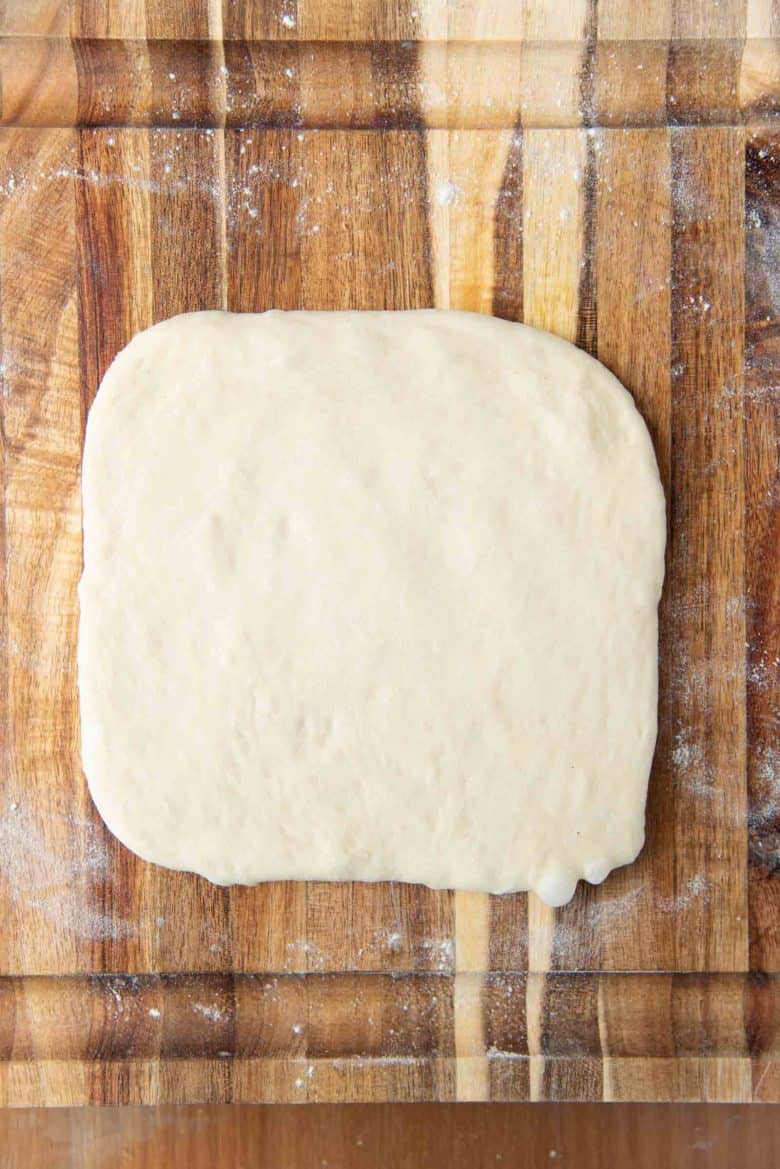 Shaping milk bread loaf - Rolled out dough into a square.