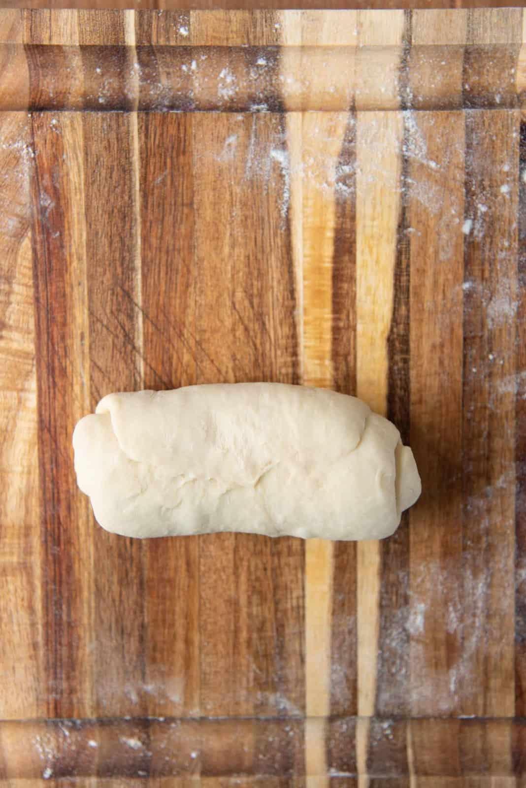 Shaping milk bread loaf - Pinch the edges to seal the seam.