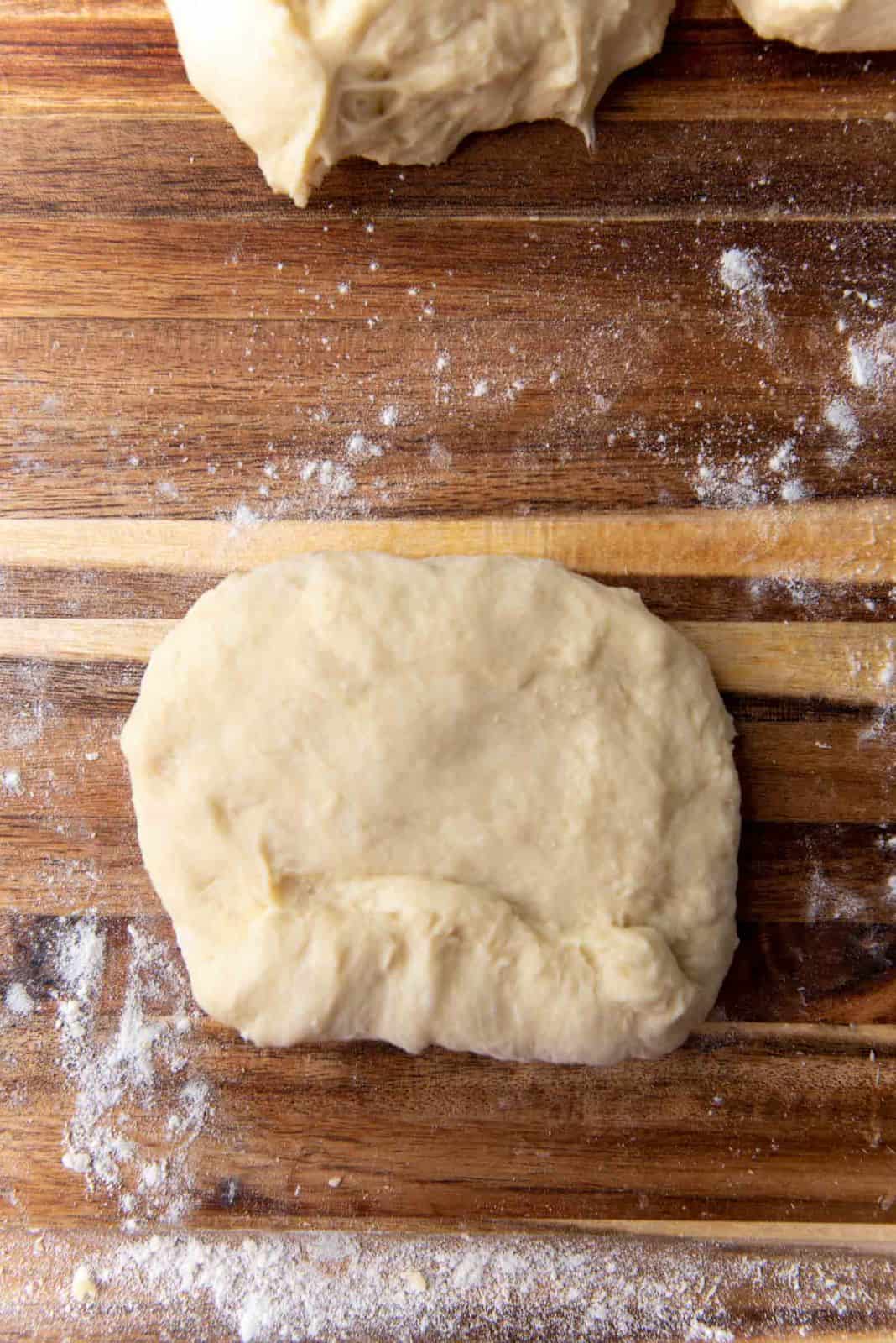 Shaping milk bread loaf - Start rolling up the dough tightly, sealing the edges as you go.