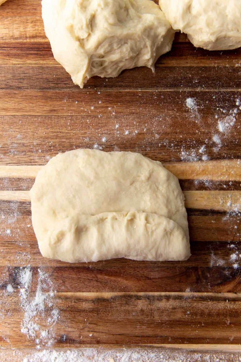 Shaping milk bread loaf - Start rolling up the dough tightly, sealing the edges as you go.