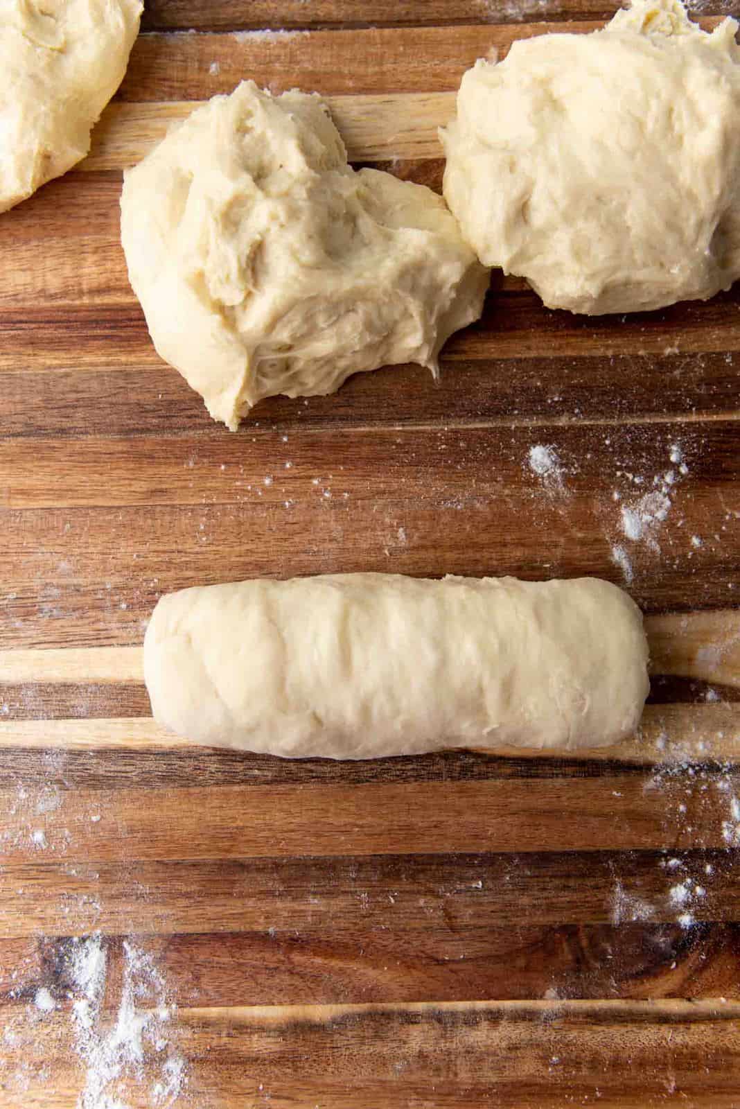 Shaping milk bread loaf - Roll it up and seal the seams and tuck under the edges to make a smooth dough roll.