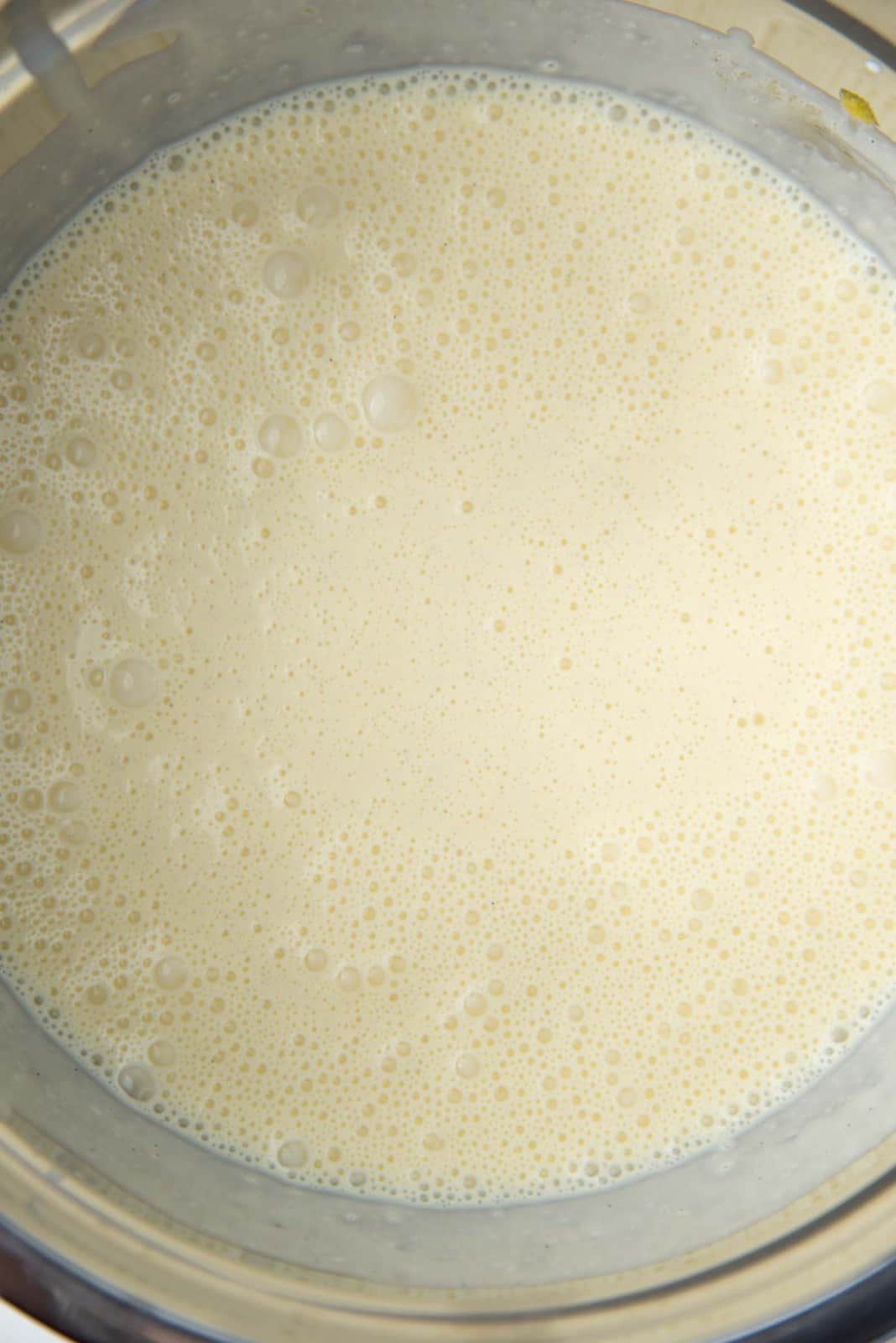 Cream whisked into the egg yolk mixture in a large bowl.