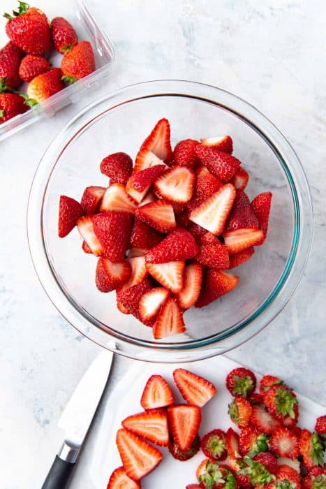 Strawberries cut in half in a large bowl