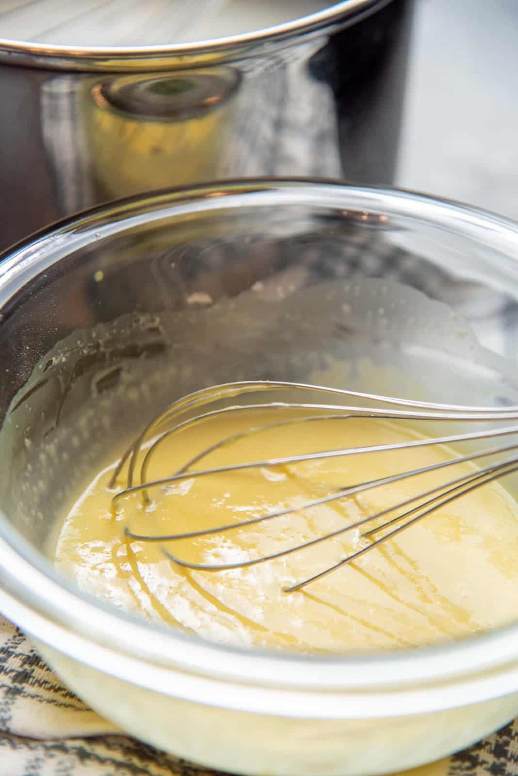 Tempering the eggs in a bowl