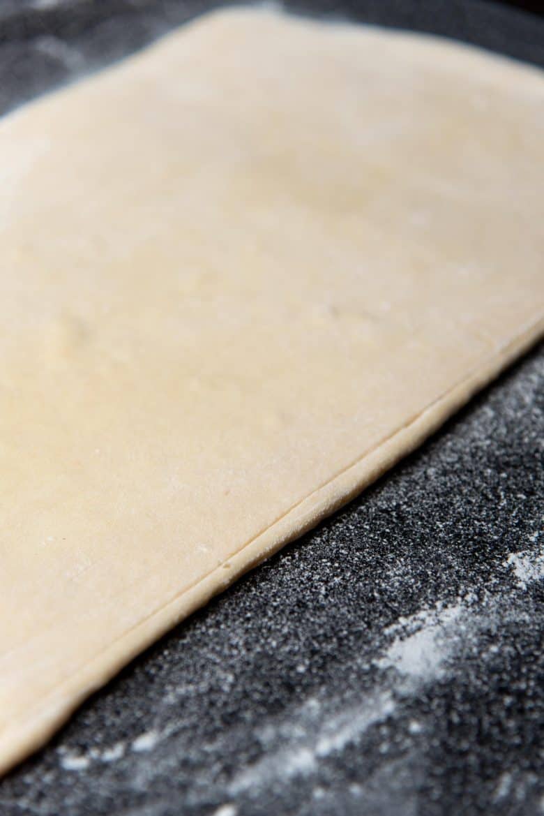 Marking the edge of the croissant dough to make straight edges