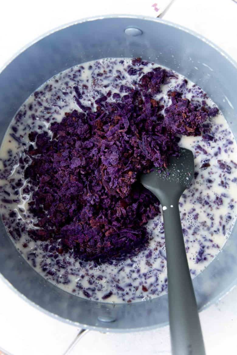 Adding the grated ube or grated sweet potato into the liquid