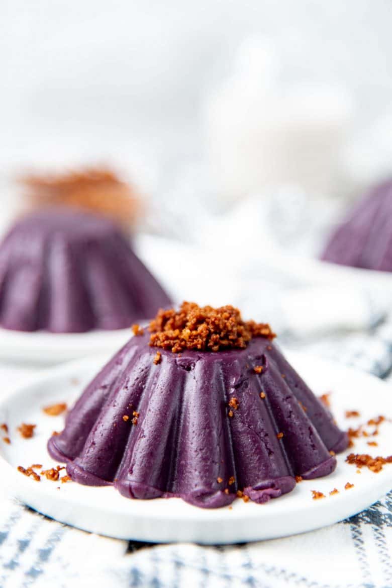Purple yam jam molded on a plate with latik on top